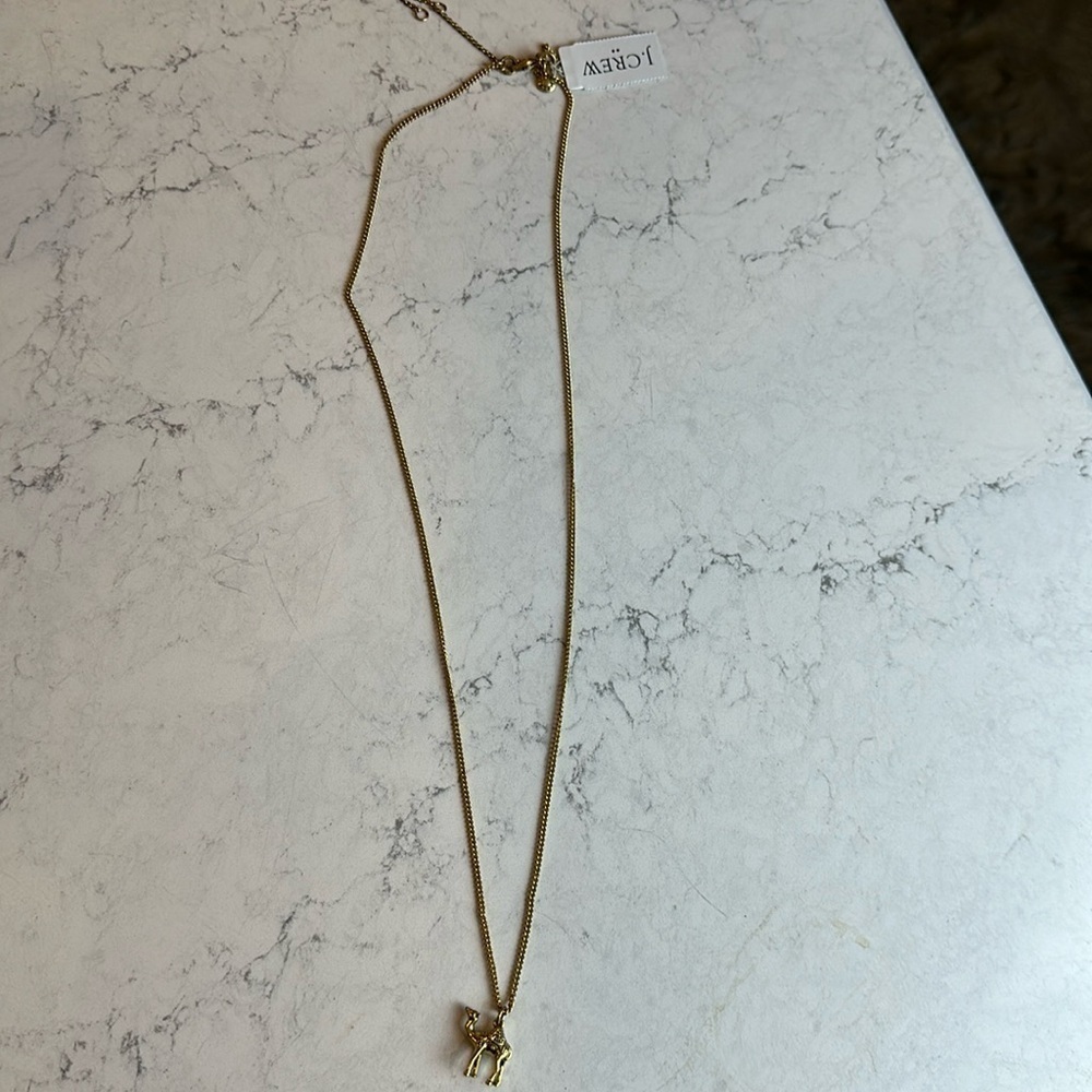 J Crew long gold tone camel charm costume necklace. NWT